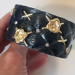 Black resin cuff bracelet with gold tone accents